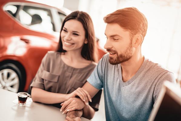 Customers in a car showroom